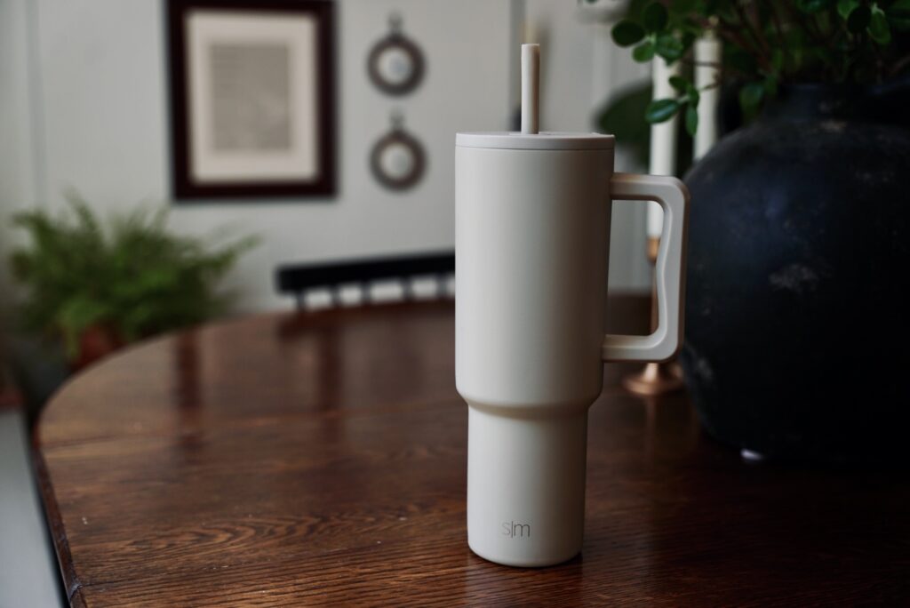 Flat lay of multiple insulated water bottles in neutral tones and trendy styles, perfect for moms, wellness routines, and on-the-go summer hydration.