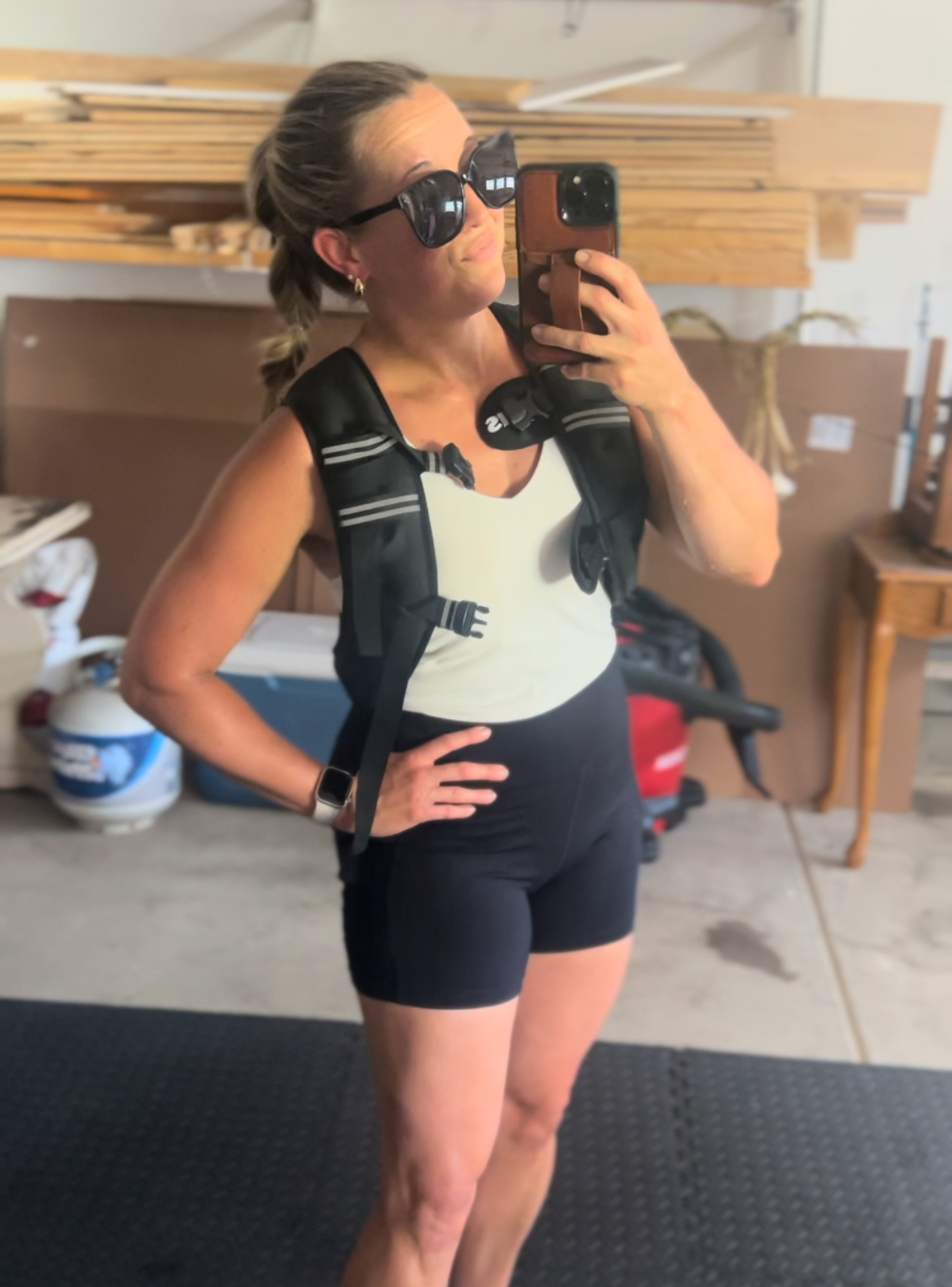 Mom wearing a weighted vest during a morning walk with two young boys, enjoying outdoor movement and summer sunshine as part of her daily wellness routine.