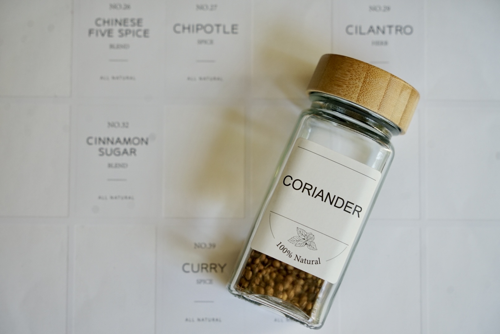 Freshly harvested coriander seeds stored in a glass bottle, with earthy tones and natural textures visible from the dried seeds.